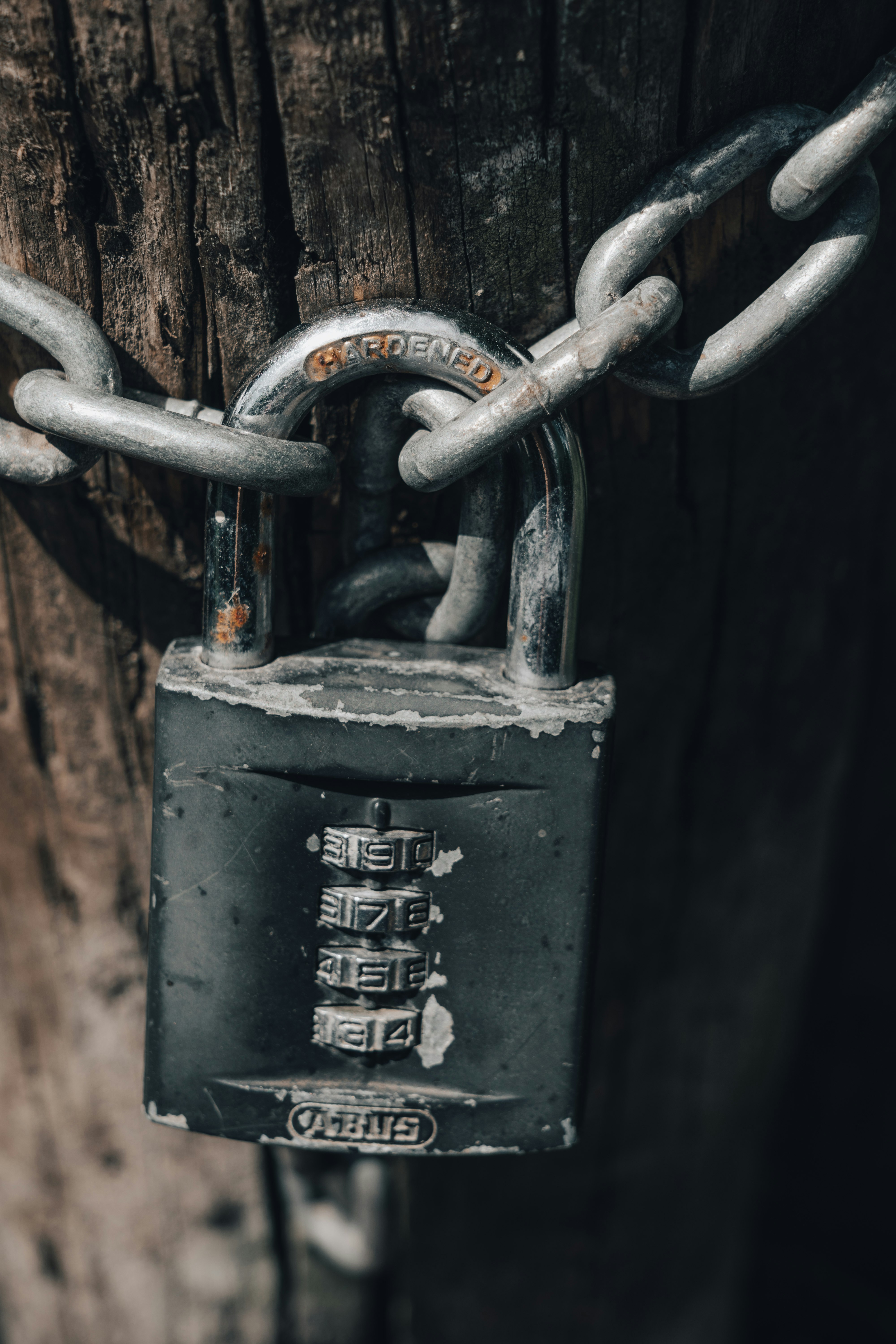 gray padlock on brown steel chain